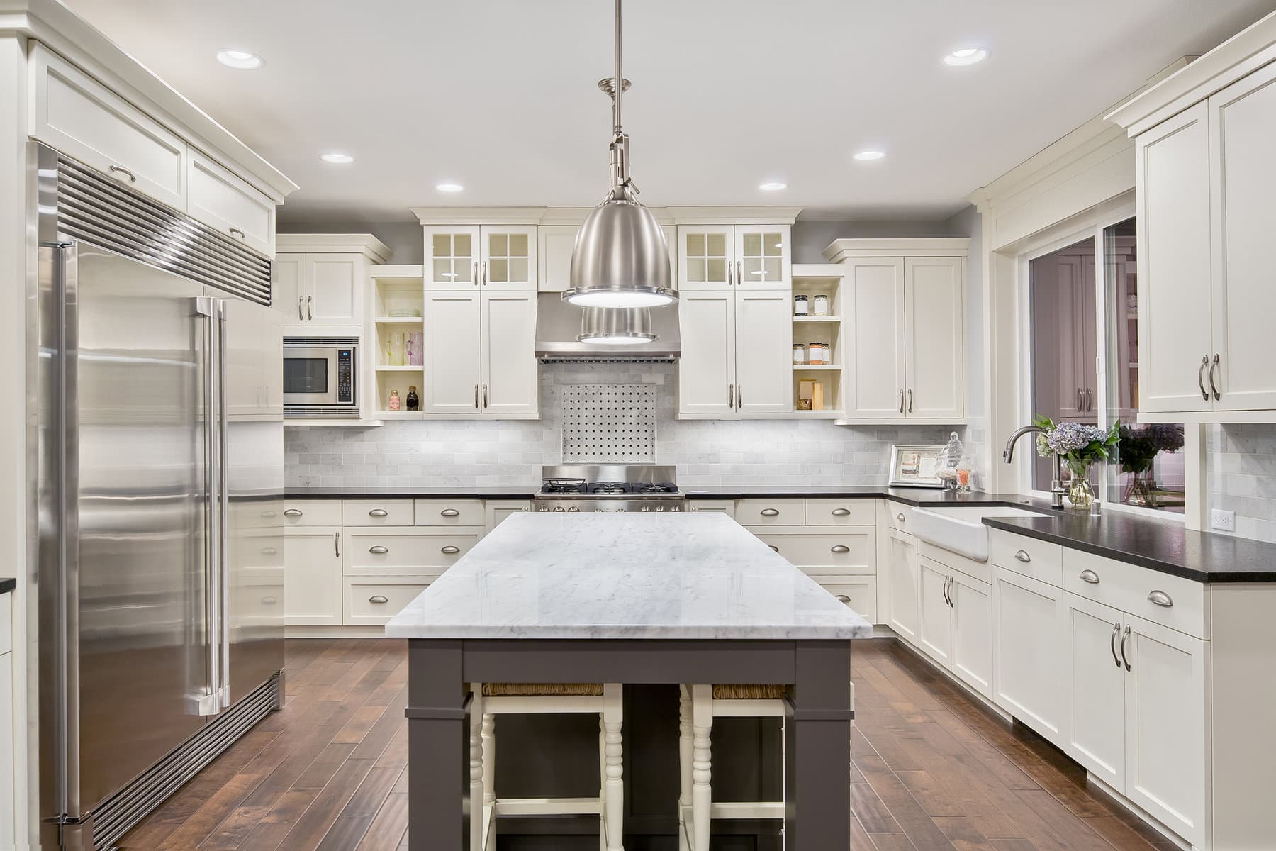 A luxury kitchen with a built-in stainless steel fridge